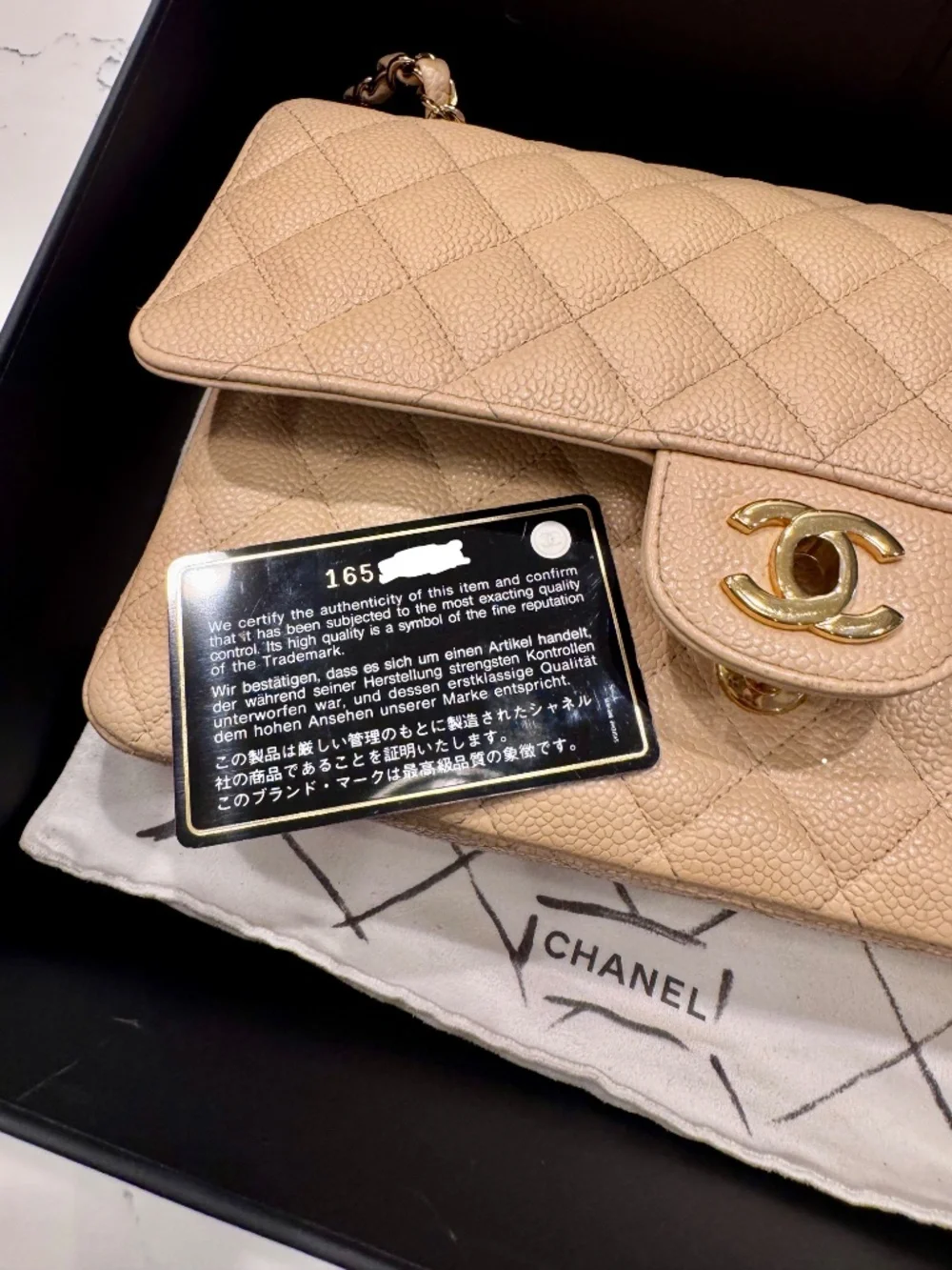 Chanel Classic Medium Double Flap in beige nude caviar with gold tone hardware.